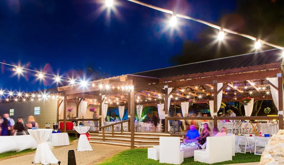 Outdoor pavilion glowing with string lights at night at Granberry Hills Event Facility in San Antonio