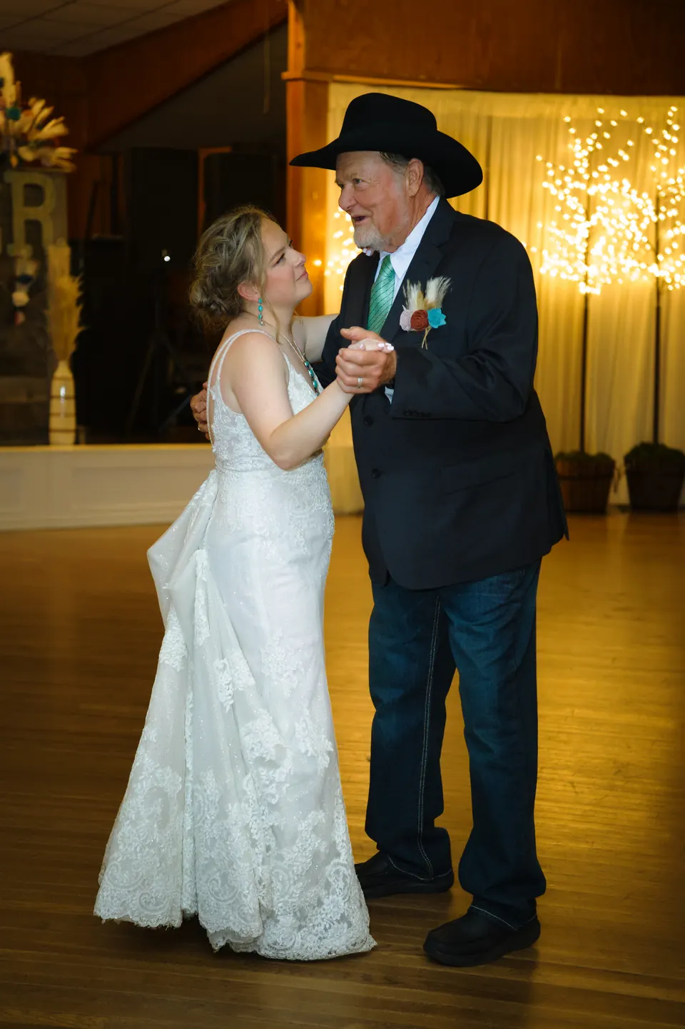Bride dancing with her father in a black cowboy hat at the Kosciusko Community Hall in Kosciusko, Texas