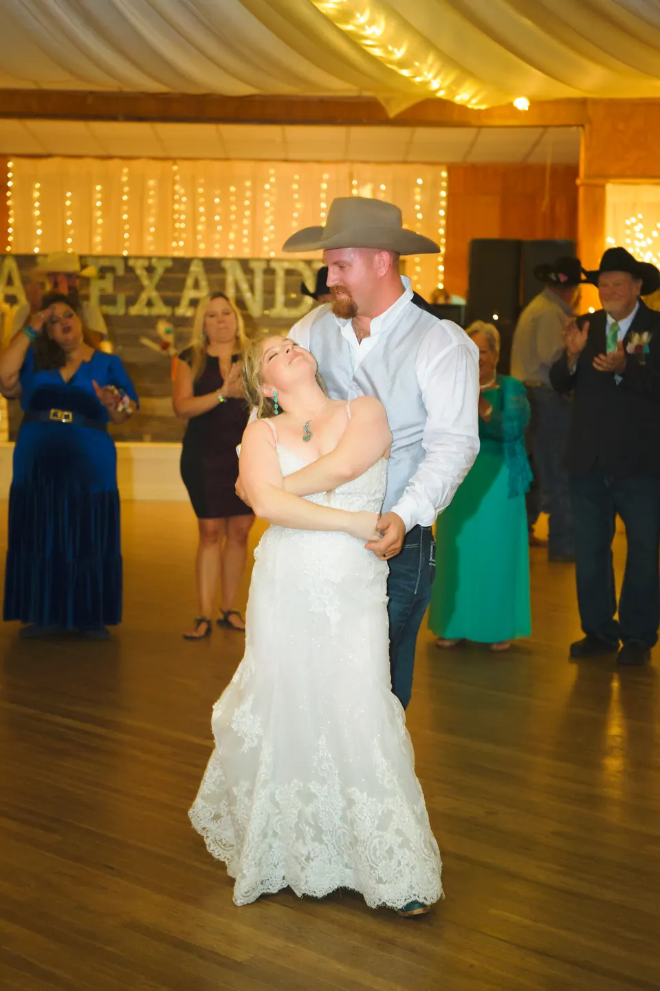 Bride and groom in a cowboy hat sharing their first dance at the Kosciusko Community Hall in Kosciusko, Texas
