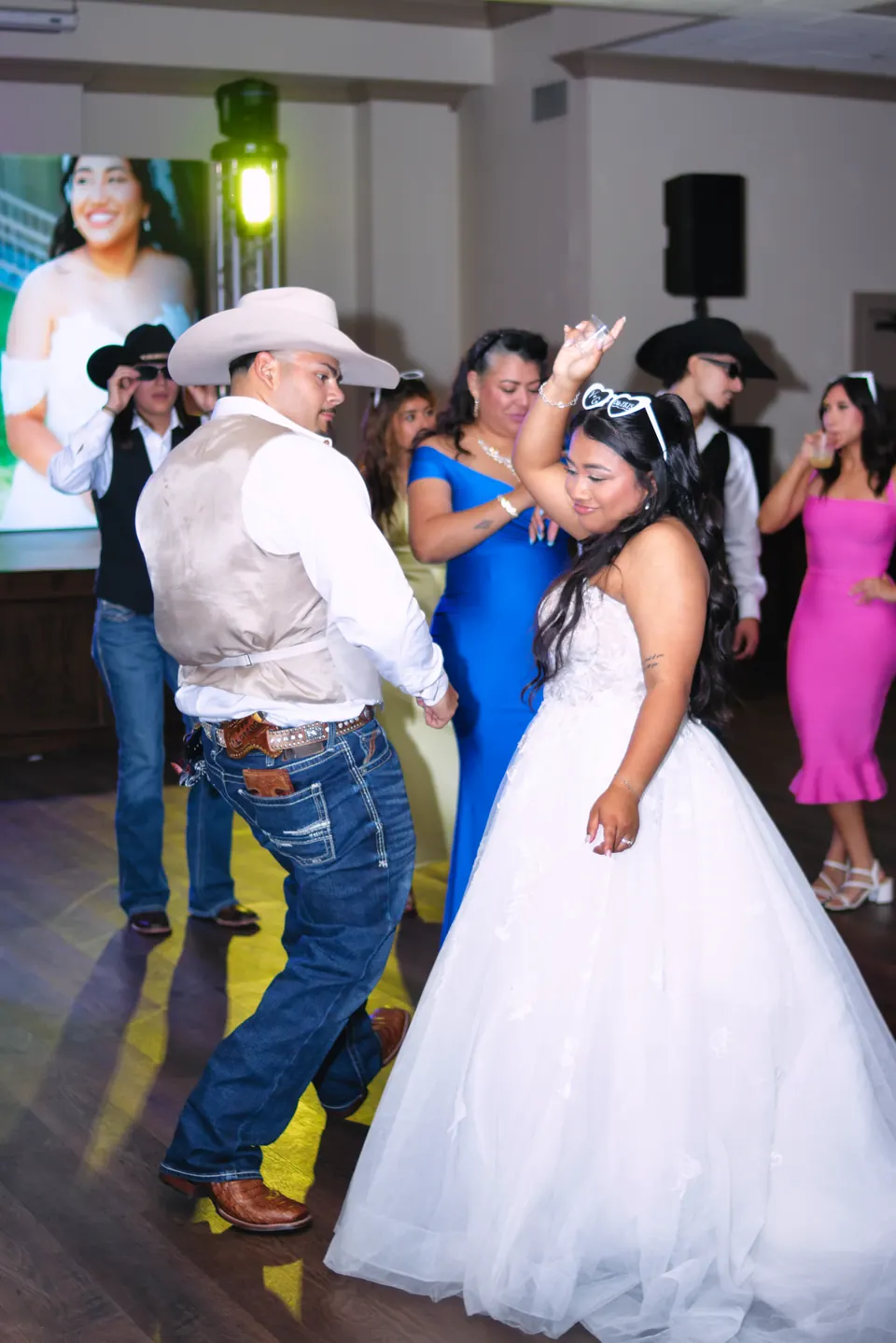 Bride dancing with guests on a packed dance floor at the Phoenician Ballroom Event Center reception in San Antonio