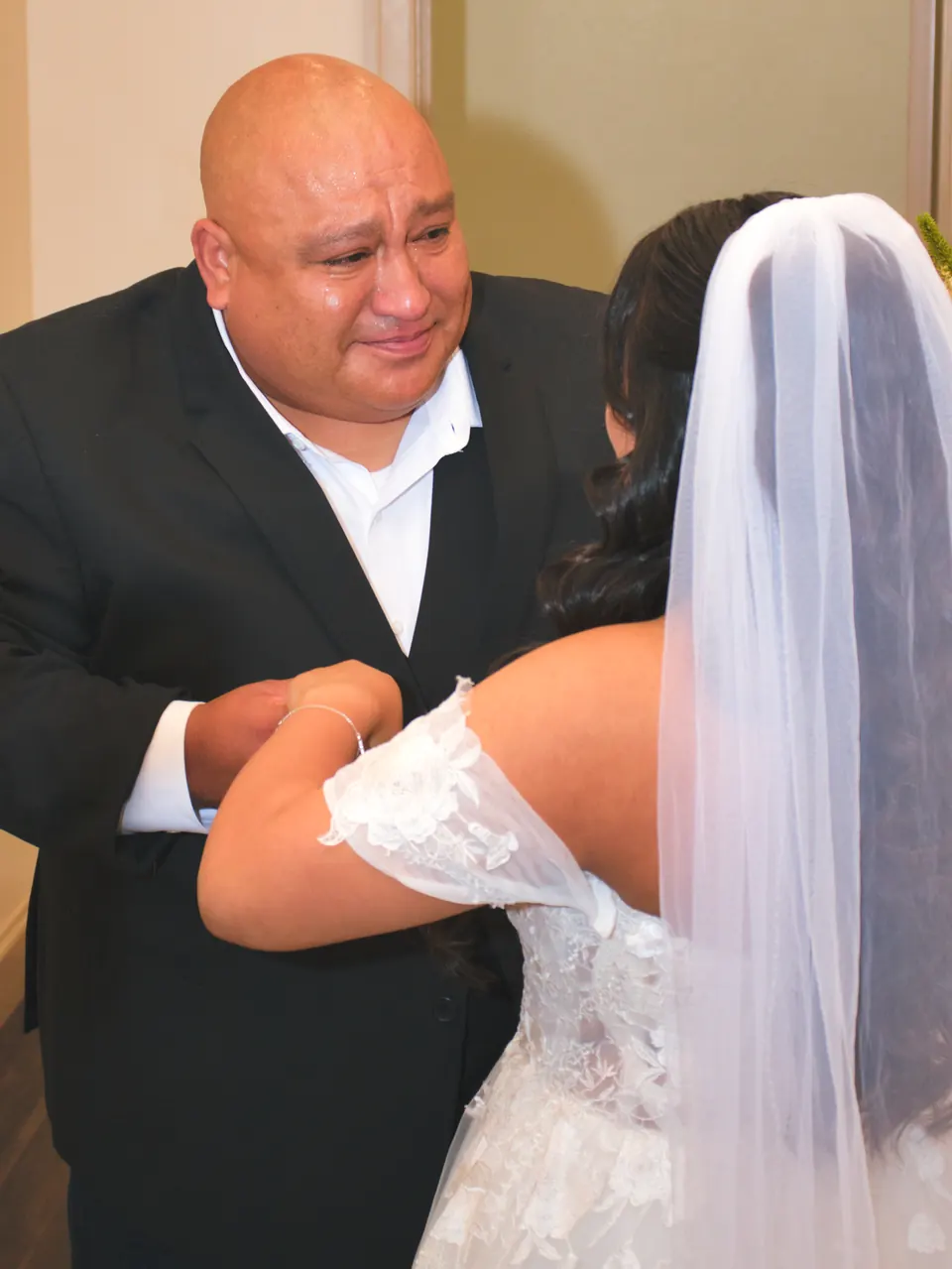 Father of the bride tearing up as he sees his daughter in her wedding dress for the first time