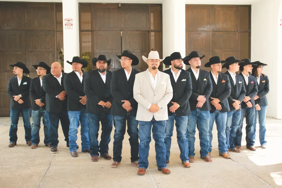 Groom in a tan blazer with his groomsmen in black cowboy hats at the Phoenician Ballroom Event Center in San Antonio