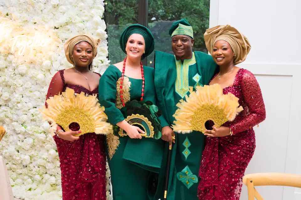 Guests in matching green and wine aso ebi with gold hand fans at The Preserve at Canyon Lake