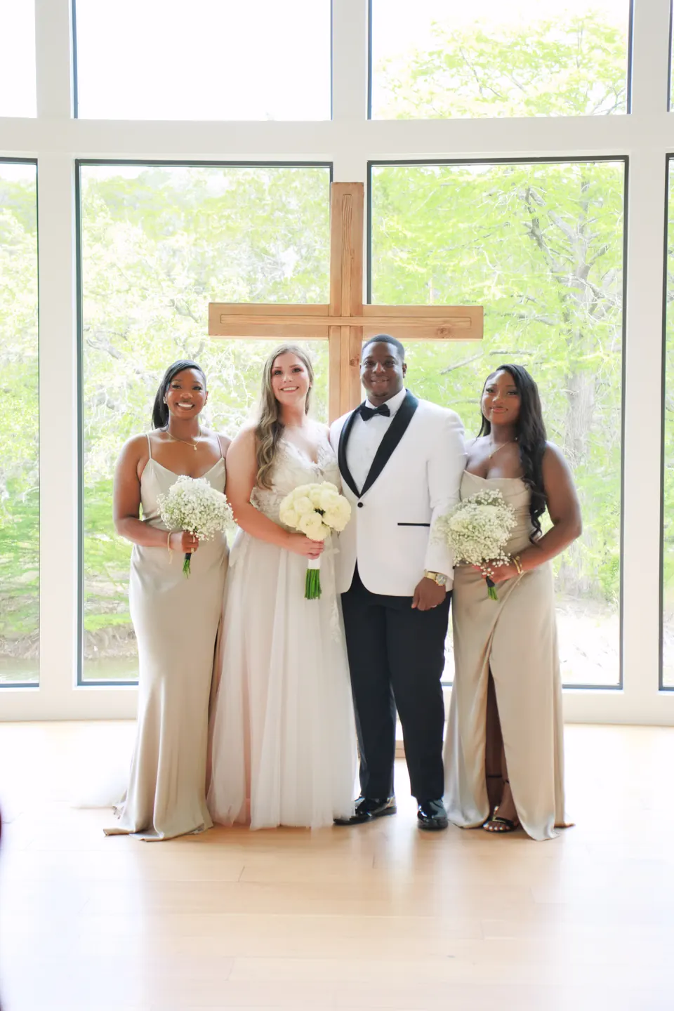 Bride and groom with bridesmaids in champagne gowns inside the chapel at The Preserve at Canyon Lake