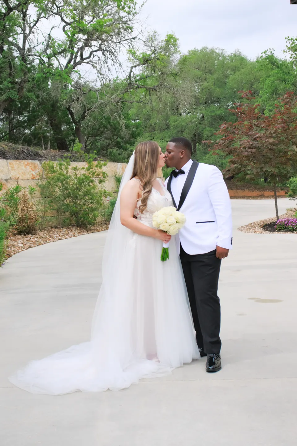 Couple sharing a kiss on the garden drive at The Preserve at Canyon Lake