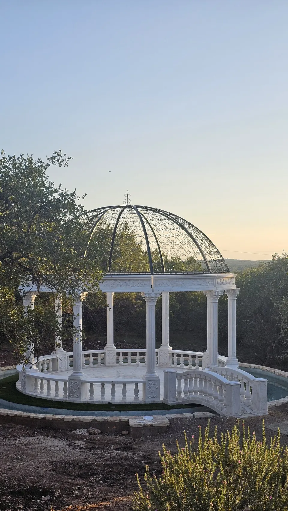 Marble dome with wrought-iron cupola at sunset over the Hill Country at Prima Vista in Wimberley, Texas
